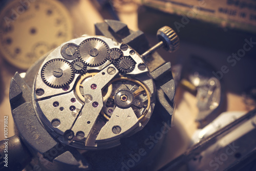 Old Watchmaker Studio. A watch makers work top. The inside workings of a vintage mechanical watch. photo