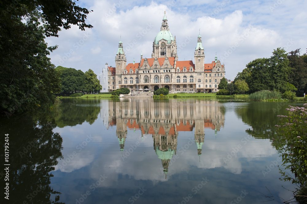 Reflection in lake of City hall in Hanover at summer day