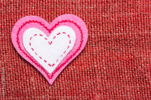 Heart shape made with cotton on linen fabric. Valentine background.