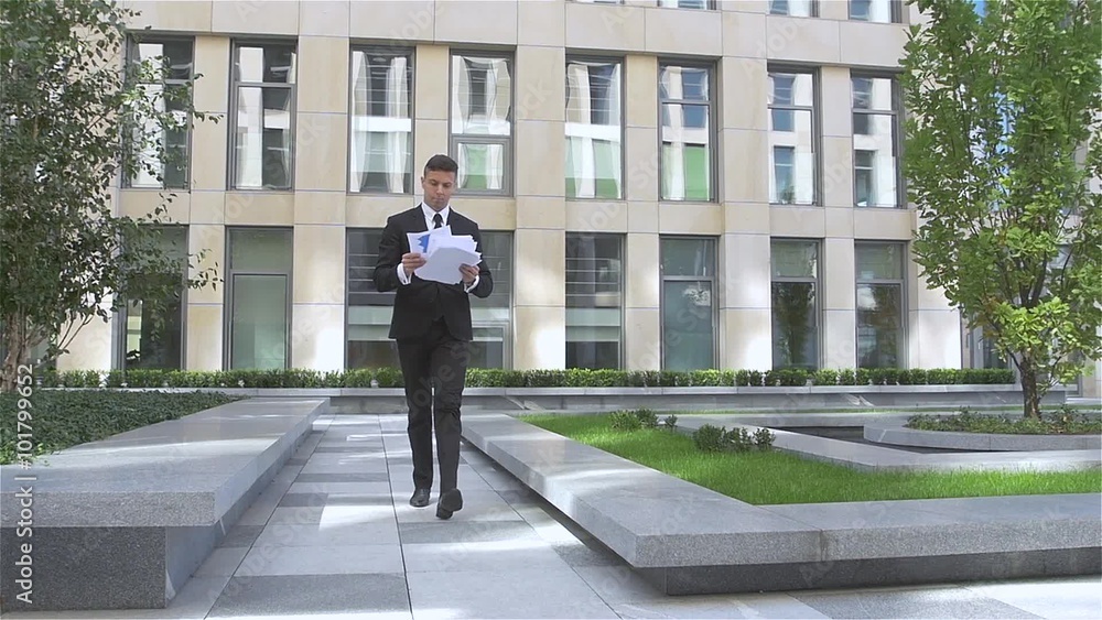 Young successful businessman throwing paper with arms in the air, slow motion Young successful businessman throwing paper with arms in the air, slow motion