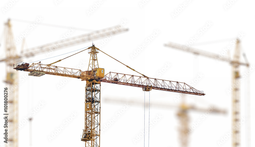 four heavy yellow hoisting cranes isolate on white