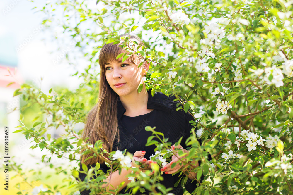 Beautiful young woman over white blossom tree, outdoors spring portrait Beautiful young woman over white blossom tree, outdoors spring portrait