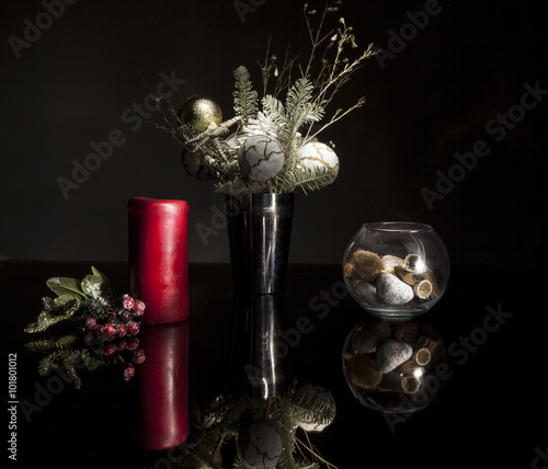 Candle and Christmas decorations on a glass table
