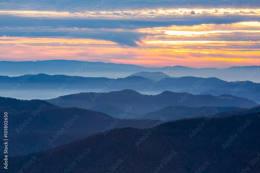 Mountains View with many stacked foggy ranges and Sunset