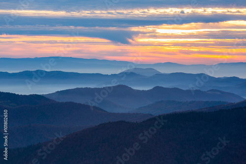 Mountains View with many stacked foggy ranges and Sunset