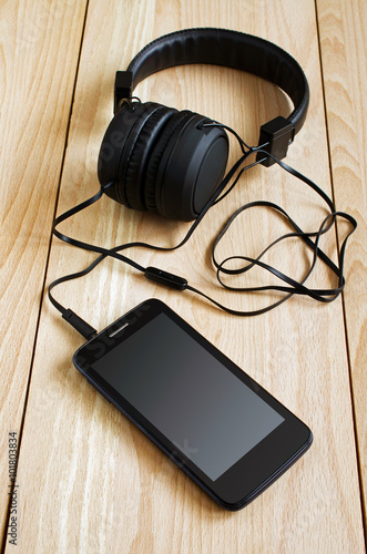 Black smartphone and headphones