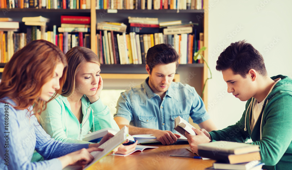 students with books preparing to exam in library students with books preparing to exam in library
