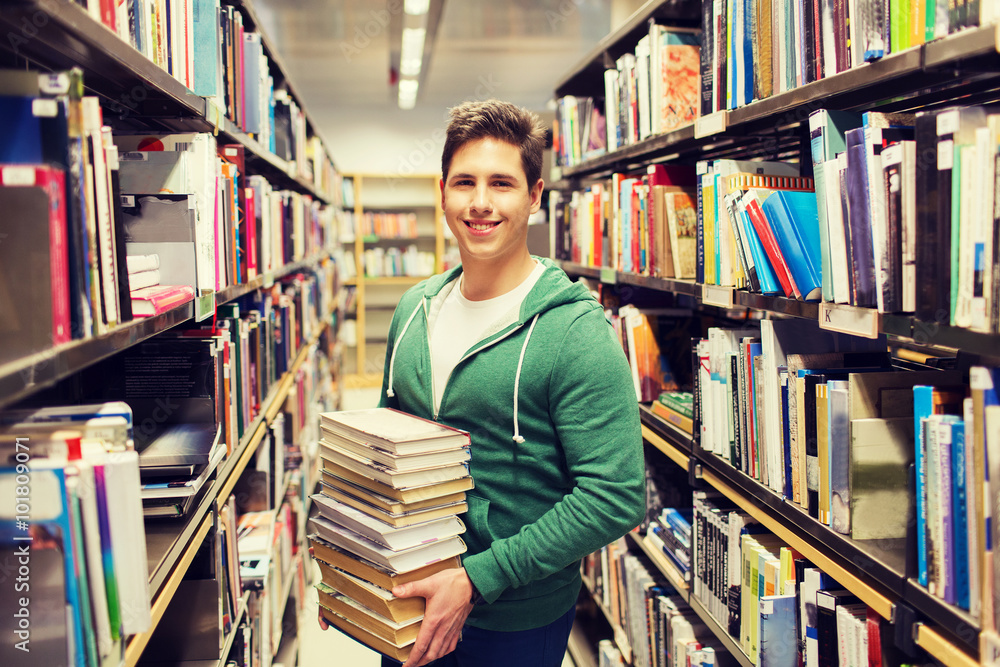 happy student or man with book in library happy student or man with book in library