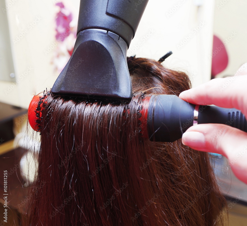 Fototapeta premium Professional drying hair in a salon closeup