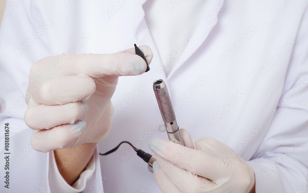 tattooist is preparing gun tool for procedure tattooist is preparing gun tool for procedure