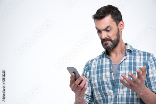 Angry man holding smartphone © Drobot Dean