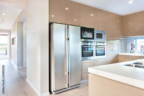 A modern refrigerator in the luxury kitchen with microwave ovens