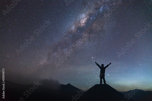 Man is spreading hand on hill and seeing the Milky Way. © chanwitohm