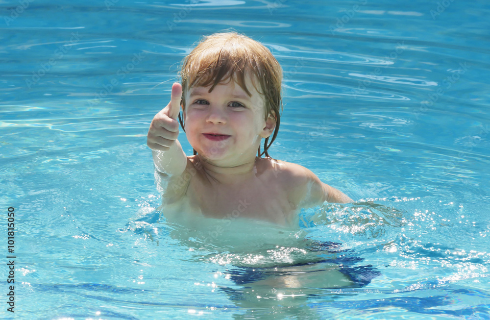 little kid happy to swim in the pool