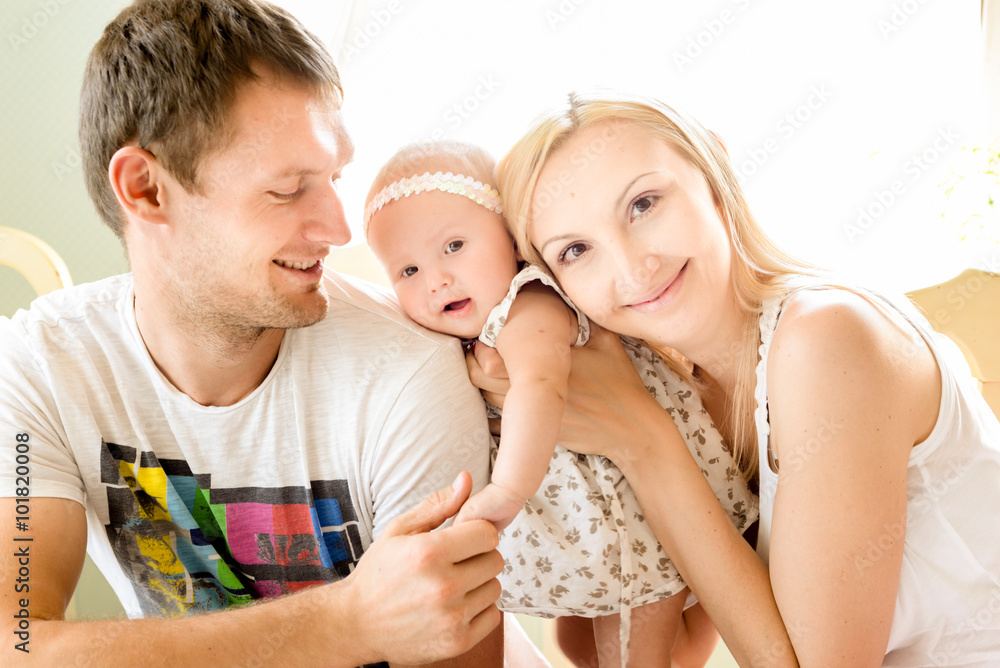 Happy young family spending time outdoors on a summer day with blue sky in background. Spending time together having fun and smiling. Parents and their child. Happy young family spending time outdoors on a summer day with blue sky in background. Spending time together having fun and smiling. Parents and their child.