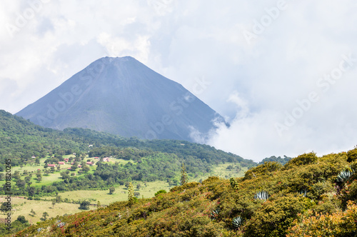 The hazy landscape showing the peak of the active Izalco volcano in El Salvador and the valley beneath it