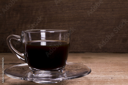 Coffee cup on wood background.