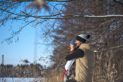 Bearded Man and woman are hugging, smiling young family hugging in the fresh winter air. Happy relationships and hugs. The pleasure of love.