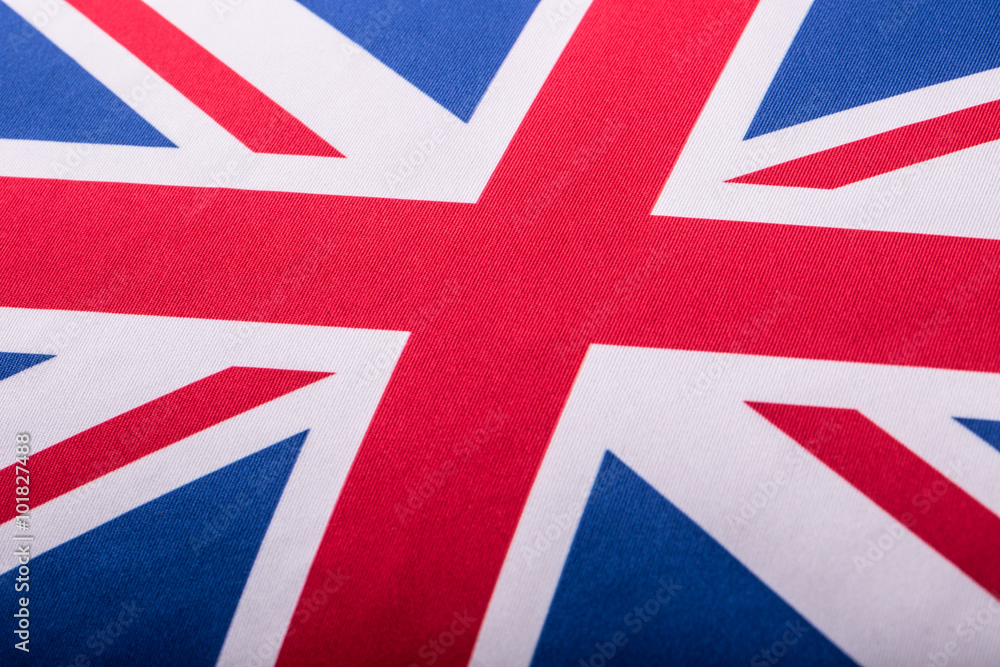Fototapeta premium Closeup of Union Jack flag. UK Flag. British Union Jack flag blowing in the wind.