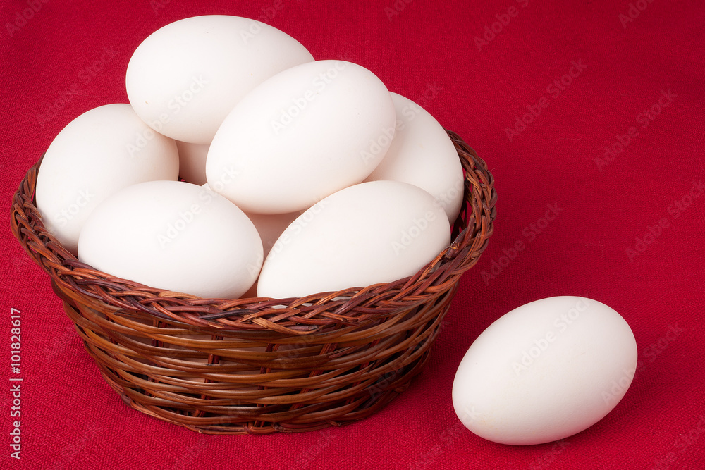 eggs in a wicker basket on red background eggs in a wicker basket on red background