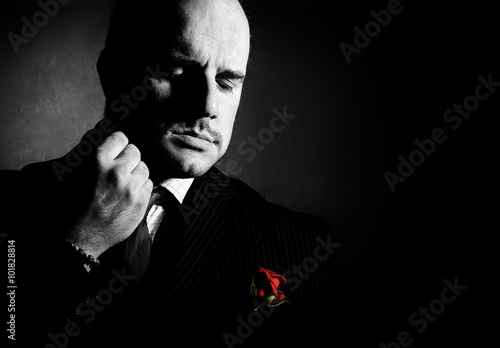 Black and white portrait of man, godfather-like character. photo