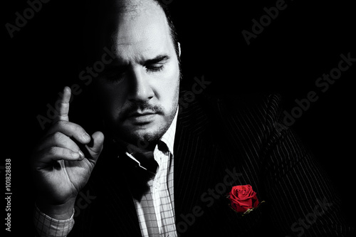 Black and white portrait of man, godfather-like character.