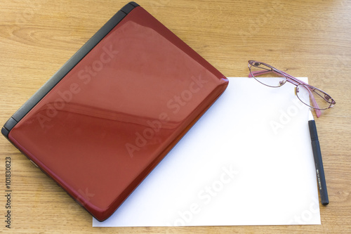 office table ,Workplace, laptop glasses and note paper on wooden