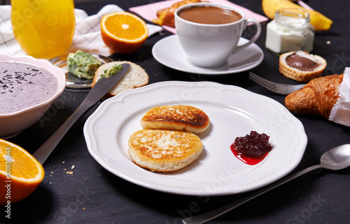 Wallpaper Mural delicious breakfast smoothie bowl, cheesecake, juice, coissant and coffee over black background Torontodigital.ca