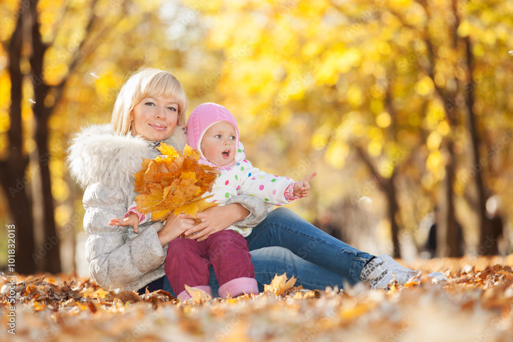 Mother and daughter in the autumn park Mother and daughter in the autumn park