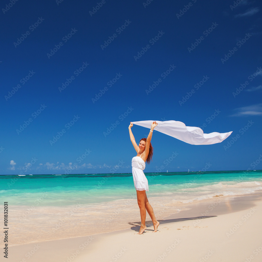 Happy young woman at the beach