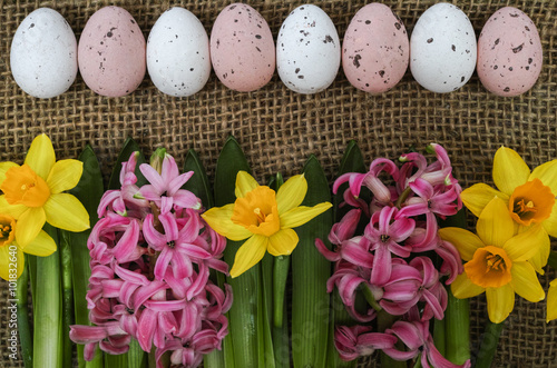 Pink and yellow spring flowers, colored eggs, Easter Sunday photo