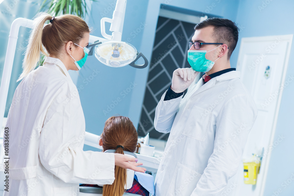 Two doctors consults before surgery at dentist office. Two doctors consults before surgery at dentist office.