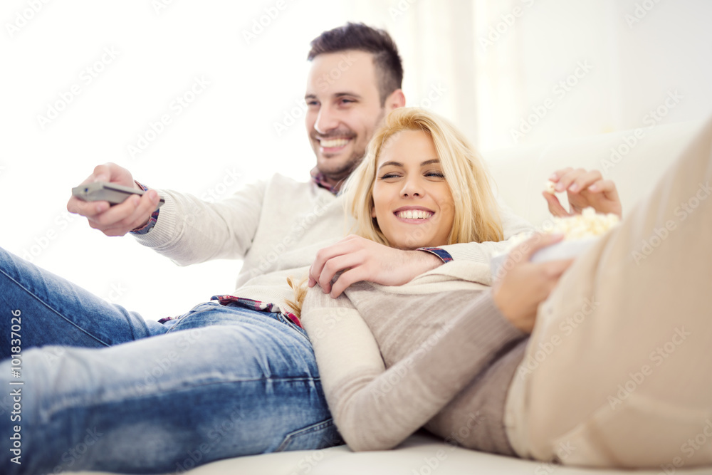 Couple at home watching TV Couple at home watching TV