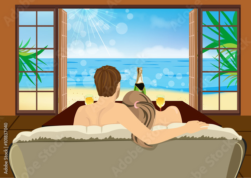 young couple sitting on the couch in a hotel room