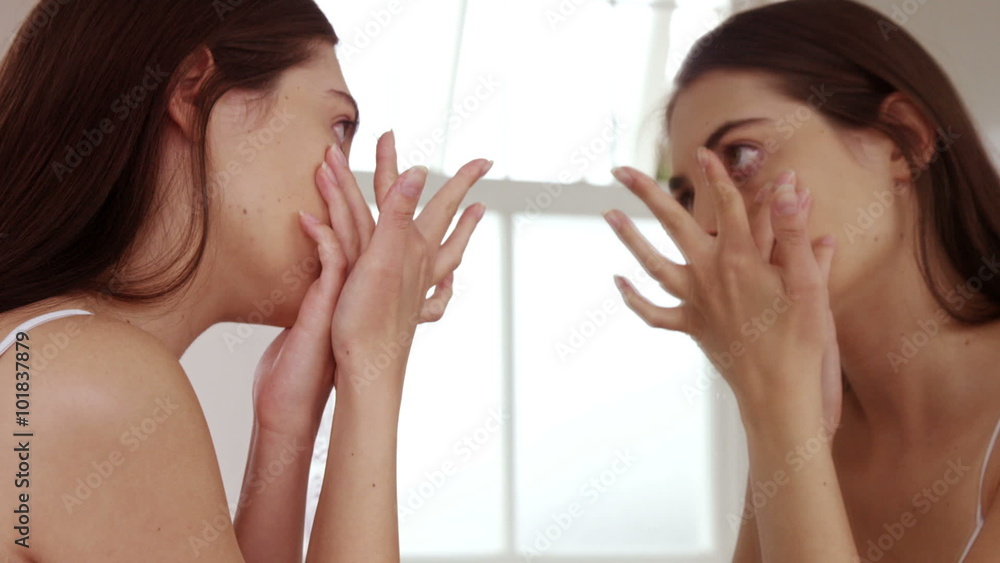 Young woman removing her contact lenses Young woman removing her contact lenses