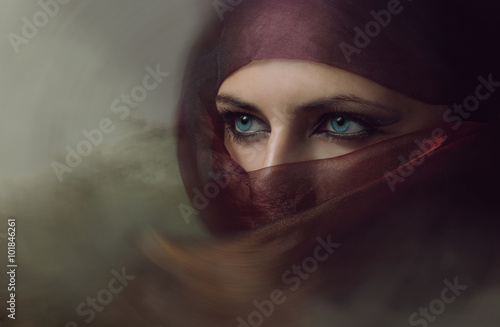 Young arabian woman in hijab with sexy blue eyes. Toning photo