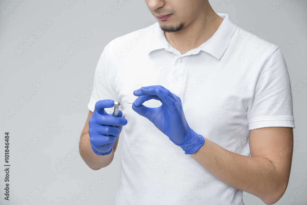 Fotografie Dentist with dental handpiece