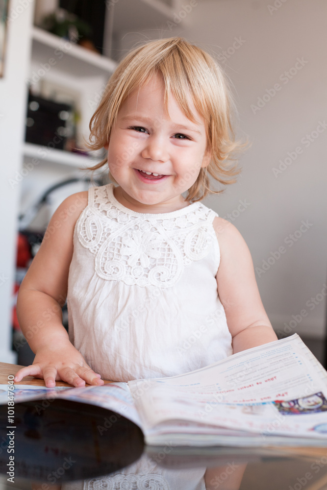 smiling baby thumbing magazine smiling baby thumbing magazine