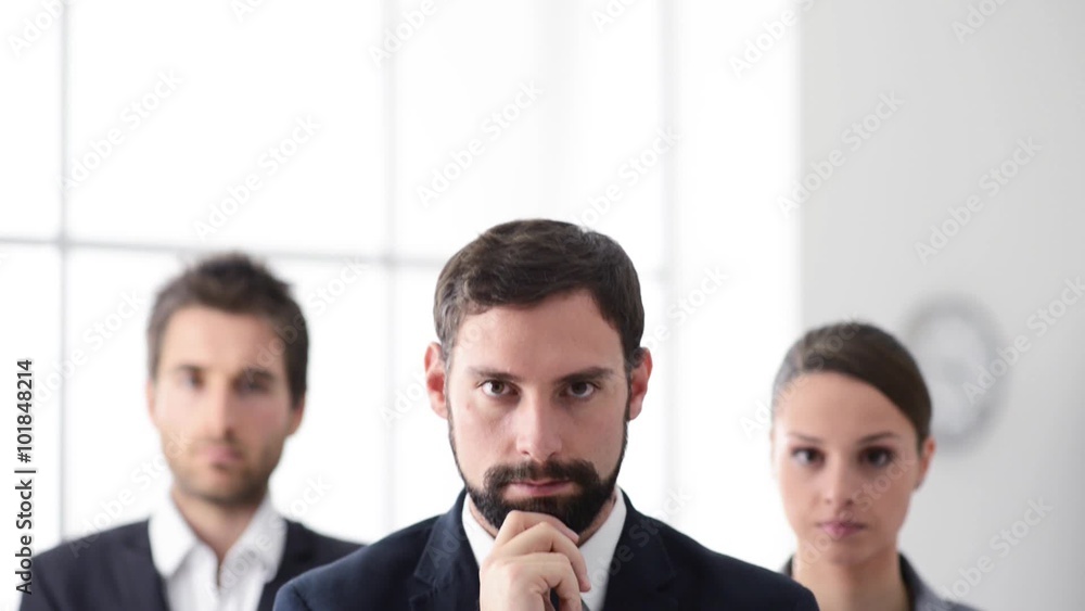 Smiling business people standing and smiling at camera, business success concept Smiling business people standing and smiling at camera, business success concept