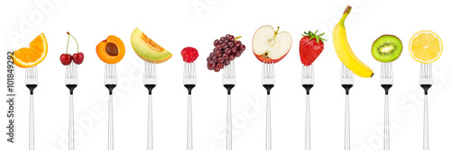 row of tasty colorful fruits on forks isolated on white background © stockphoto-graf