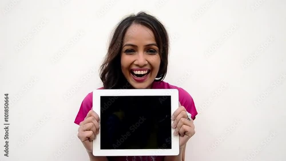 Shot of a woman holding a digital tablet and laughing Shot of a woman holding a digital tablet and laughing