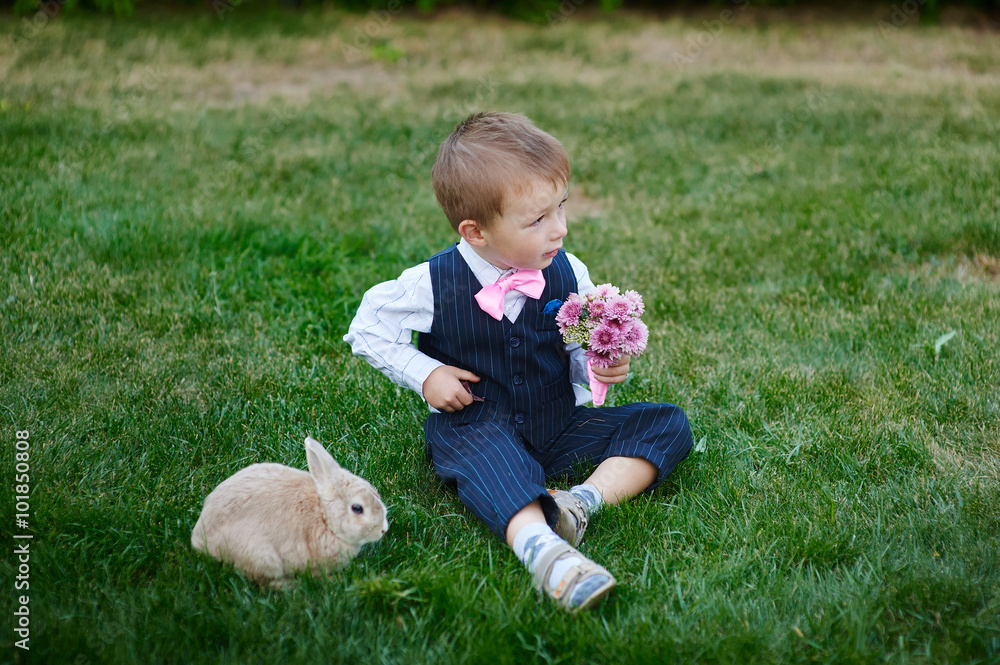 little boy in suit with a bouquet and a rabbit little boy in suit with a bouquet and a rabbit