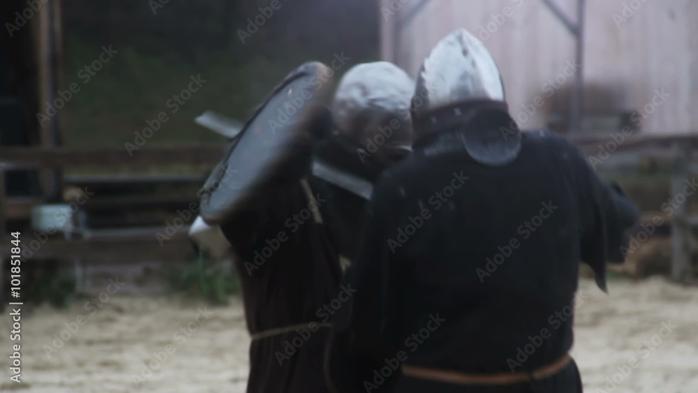 Brave soldier repelling active attack of violent rival during martial tournament Brave soldier repelling active attack of violent rival during martial tournament