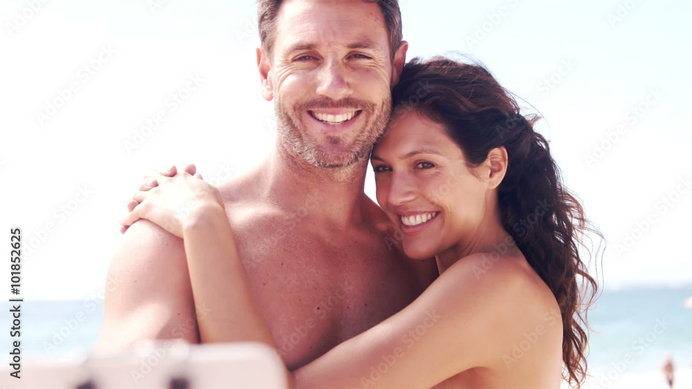 Happy couple taking selfie at the beach Happy couple taking selfie at the beach