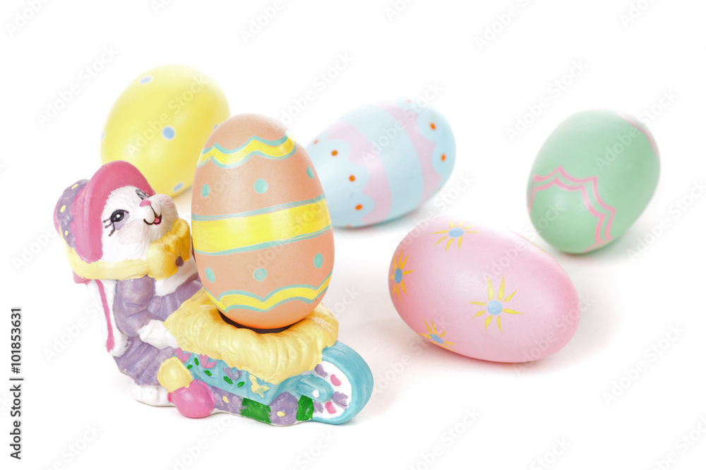 Colorful Eggs with Easter Bunny Figurine on a White Background Colorful Eggs with Easter Bunny Figurine on a White Background
