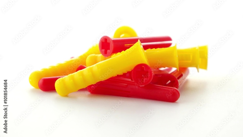 Closeup of colorful plastic dowels isolated on white background. Closeup of colorful plastic dowels isolated on white background.