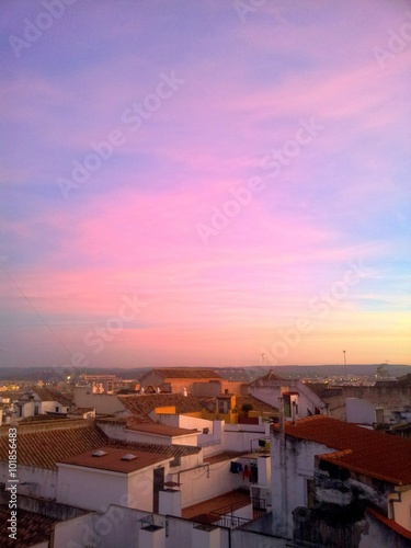 Rooftops at sunset with colorful sky © LUMA