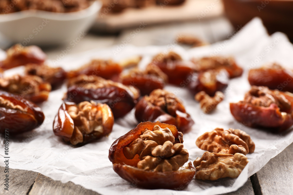 Walnut and date fruit on wooden table, close-up Walnut and date fruit on wooden table, close-up