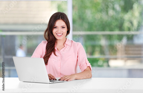 Young woman working with laptop in the office