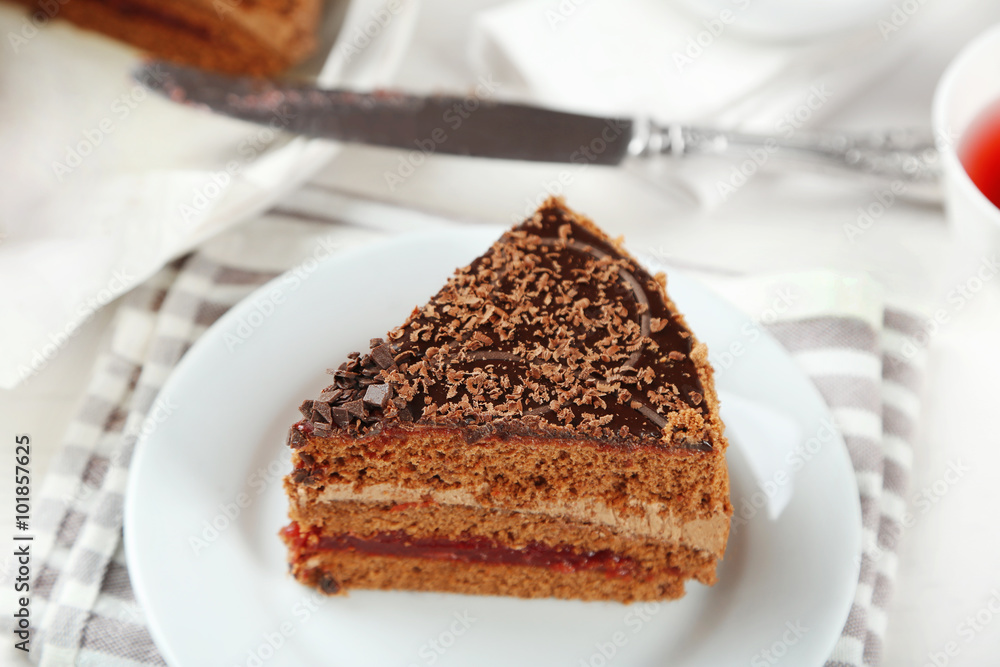 Sliced chocolate cake on plate, on wooden table background Sliced chocolate cake on plate, on wooden table background